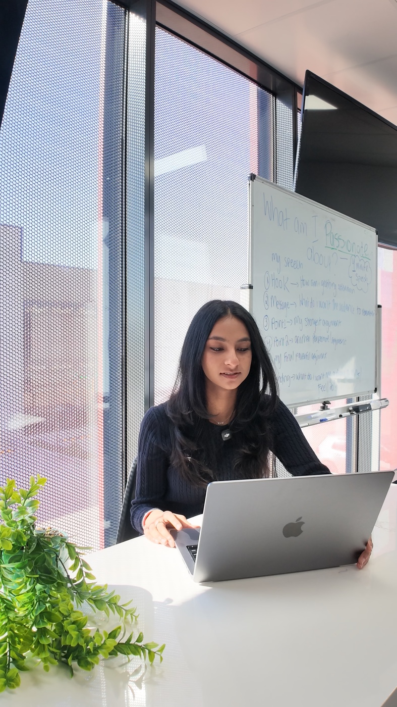 Ananya working at her laptop in the Aspire centre